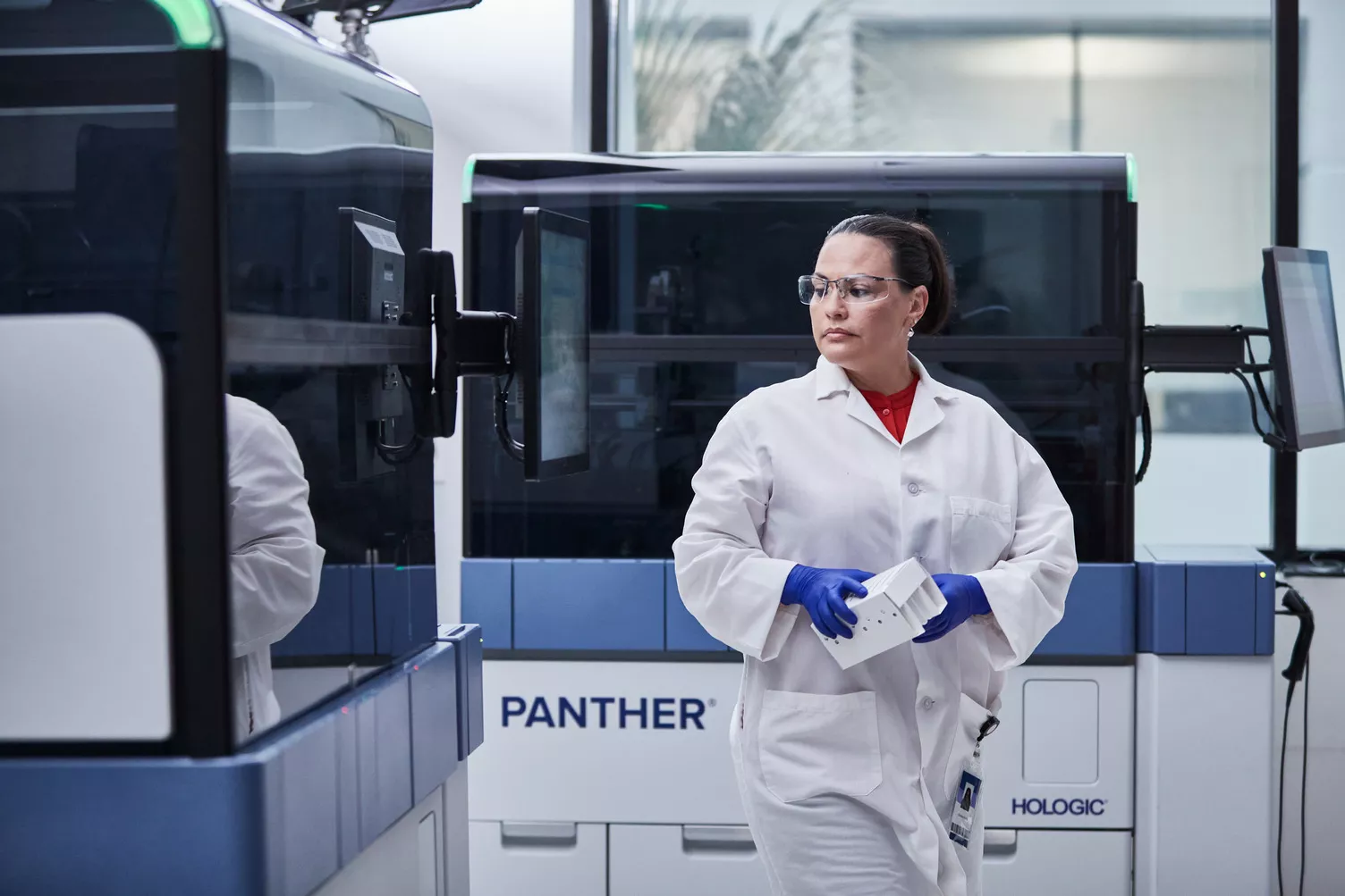 Lab technician surrounded by Panther equipment