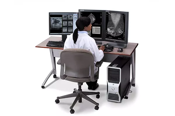 Workstation with clinician looking through scans