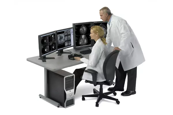 Medical workstation with clinicians looking at mammography scans